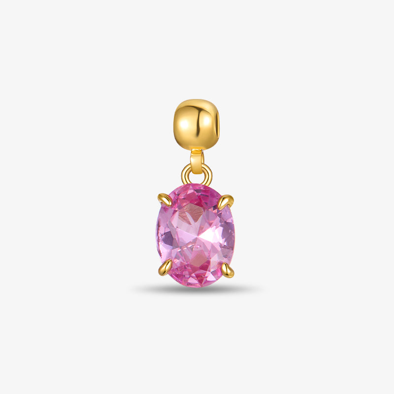 Gold-plated earring charm with oval pink gemstone on white background