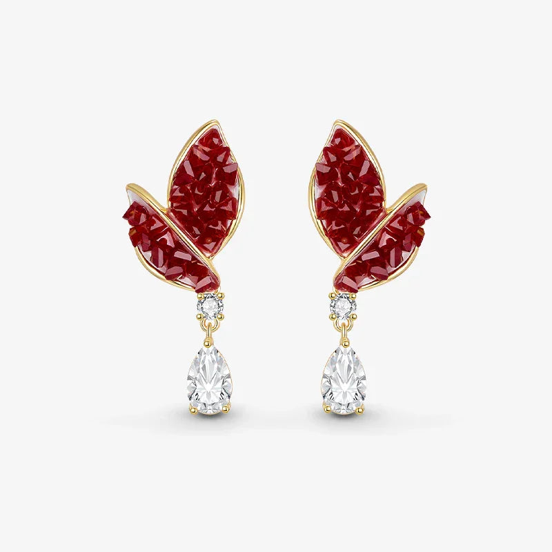 Gold-plated earrings with red leaf design and teardrop clear crystals on white background