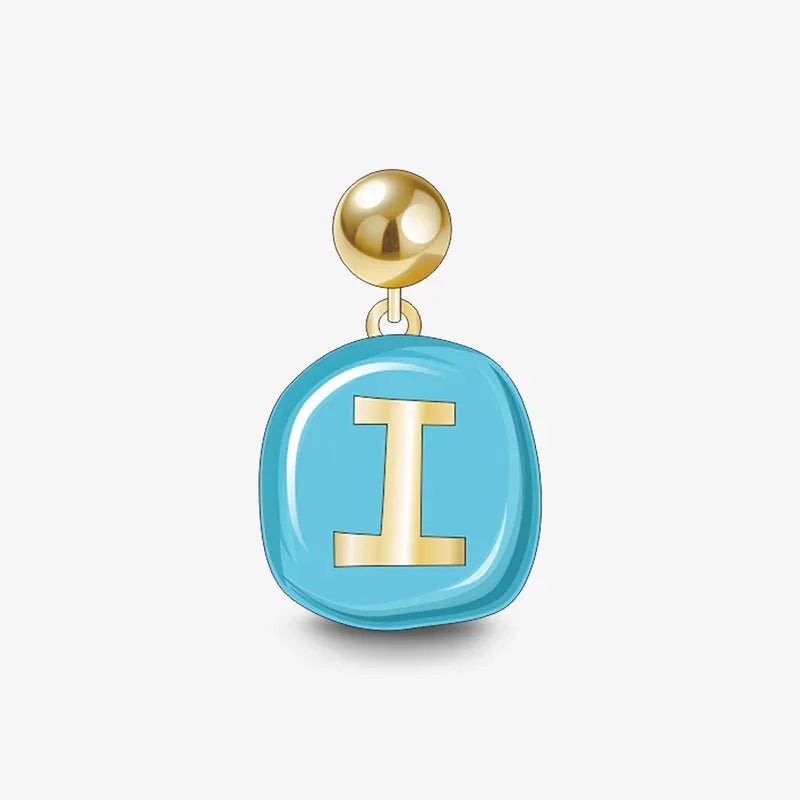 Gold and blue enamel initial I stud earring, modern jewelry against white background