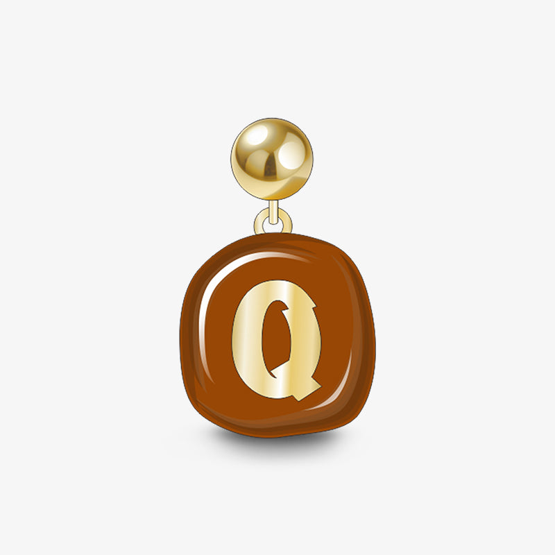 Gold-plated statement earring with brown enamel and gold letter Q charm on white background