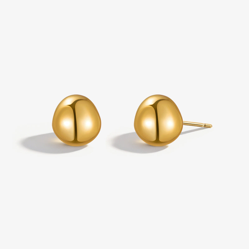 Minimalist gold-plated stud earrings with organic rounded shape on white background