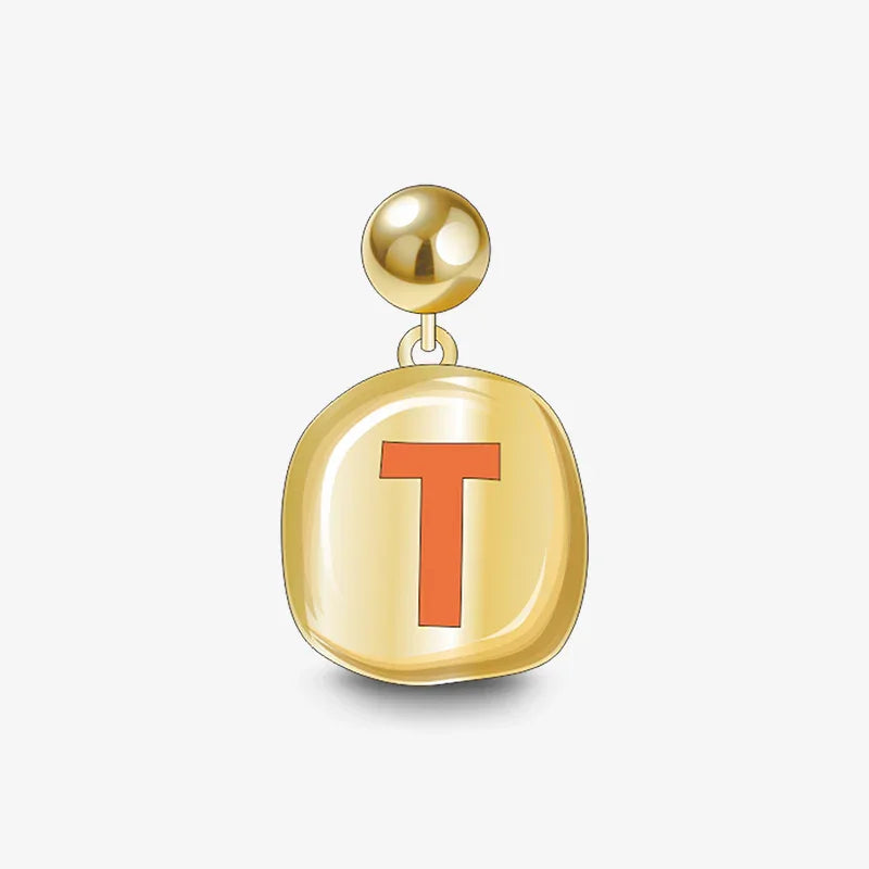 Gold-plated earring with orange letter T charm, statement jewelry on white background.