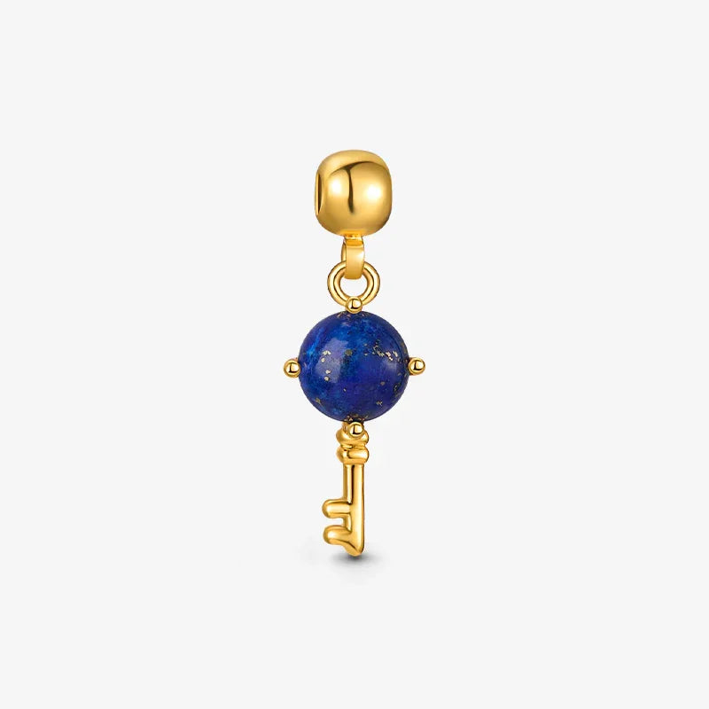 Gold-plated key charm pendant with blue gemstone, elegant jewelry accessory