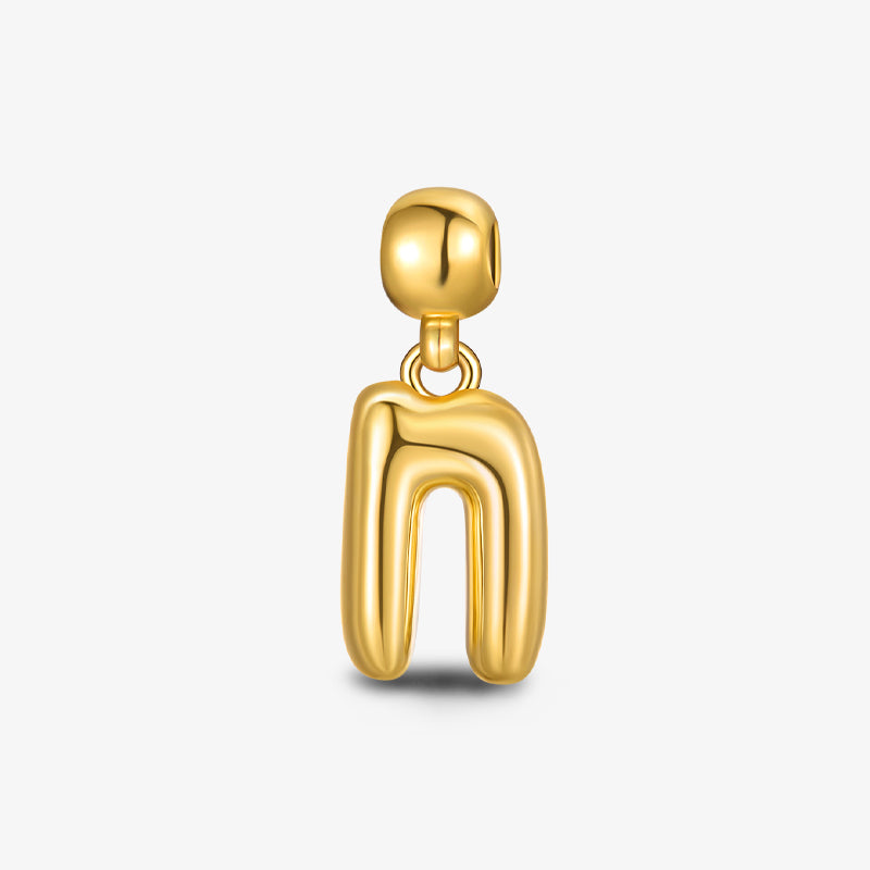 Modern gold-plated abstract pendant charm on white background, elegant jewelry accessory