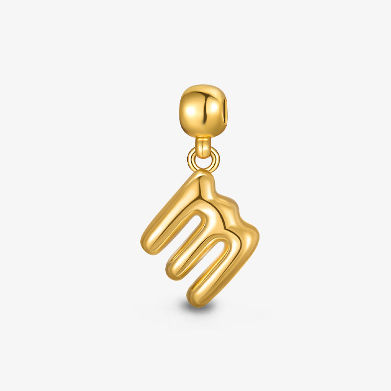Gold-plated charm with abstract wavy design on white background