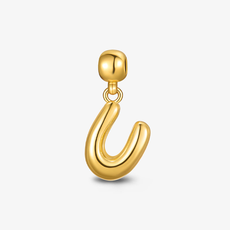 Gold-plated charm pendant in the shape of a bold, modern U on white background