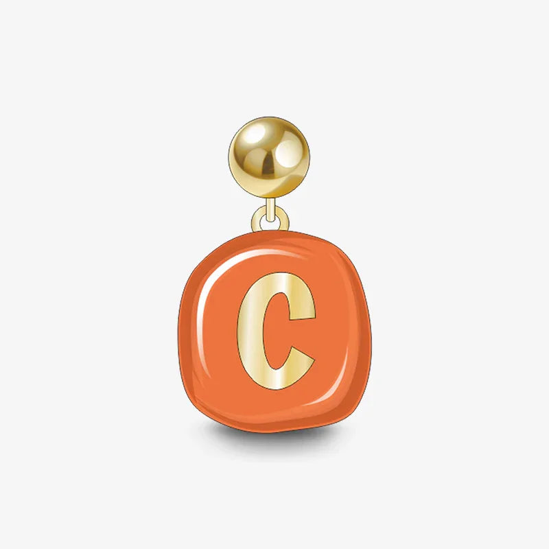 Gold-plated earring with orange enamel pendant and gold letter C on white background