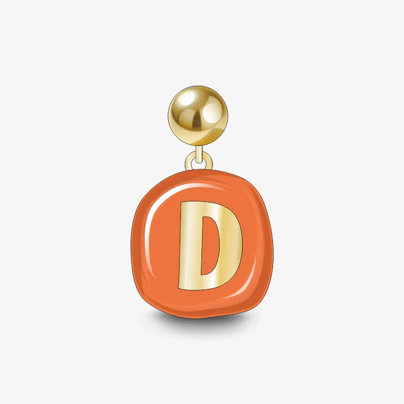 Gold-plated earring with orange enamel pendant and letter D charm on white background