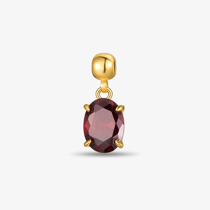 Gold-plated pendant with oval red gemstone on white background
