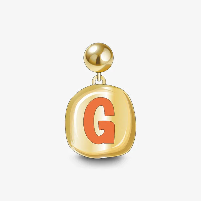 Gold-plated letter G charm earring with orange enamel on white background
