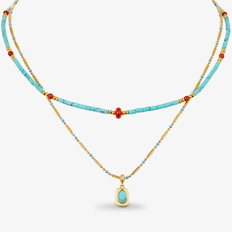 Layered turquoise and gold beaded necklace with pendant, accent red beads, minimalist style