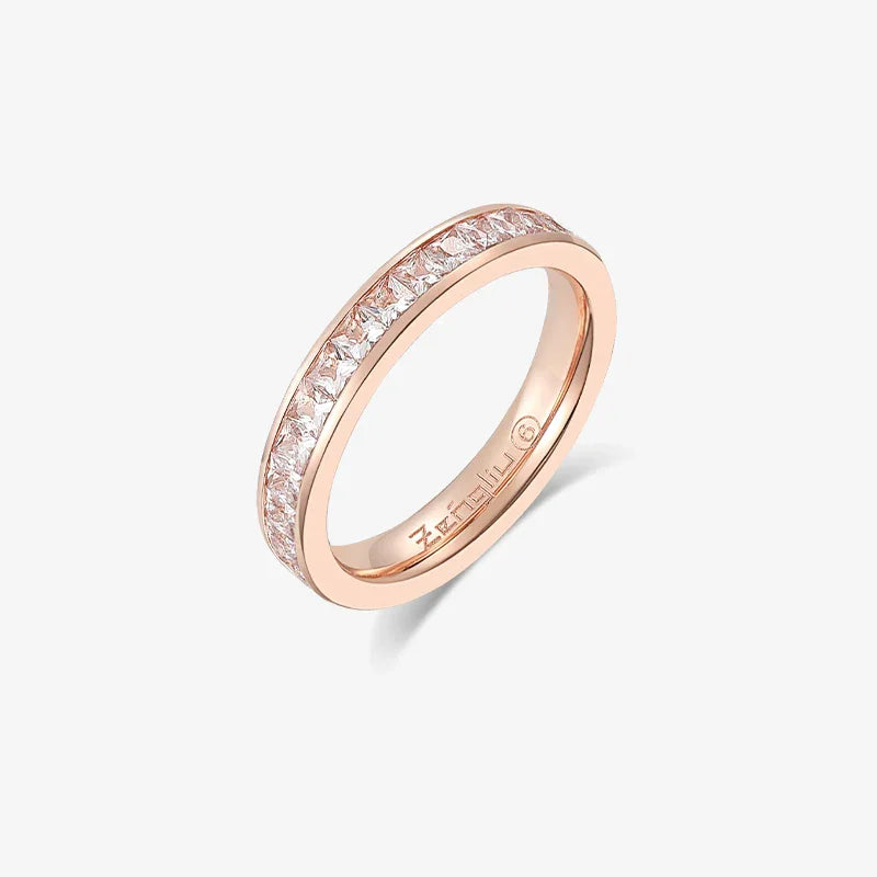 Gold-plated band ring with channel-set square white crystals on a white background