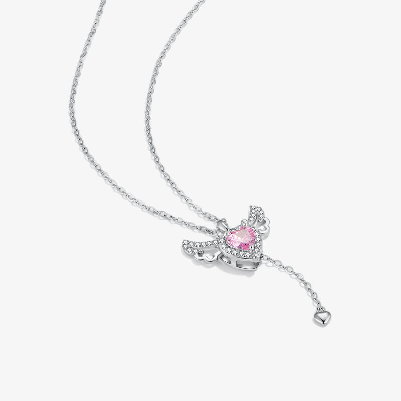 Silver necklace with angel wing pendant, heart-shaped pink gemstone and crystal accents.