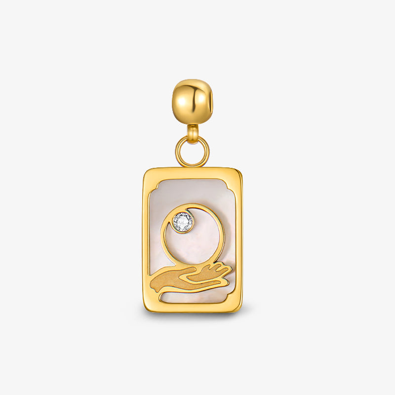 Gold-plated rectangular pendant with hand and moon design, white inlay, and clear gemstone accent