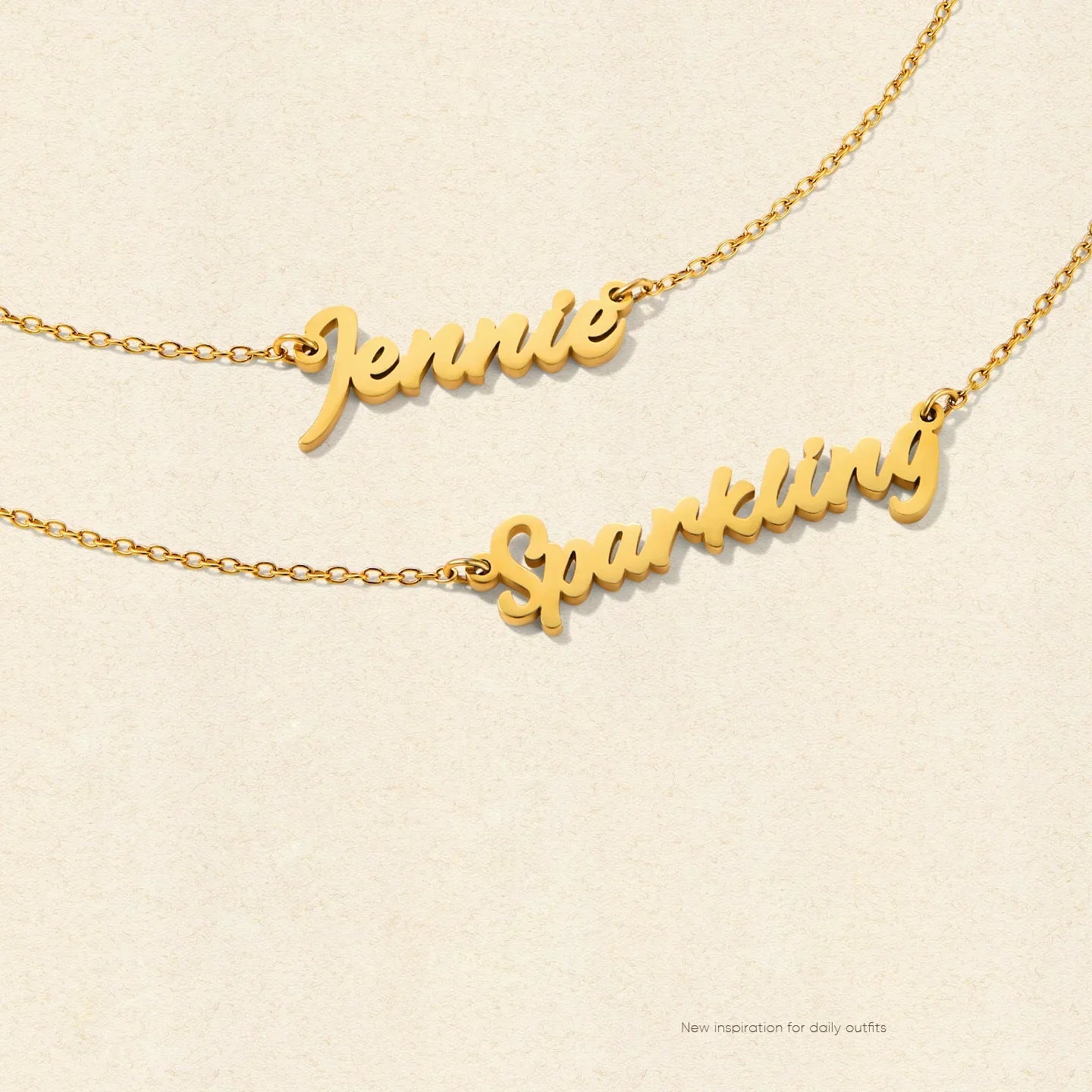 Gold-plated nameplate necklaces with 'Jennie' and 'Sparkling' on delicate chains