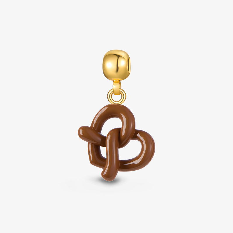 Gold-plated necklace pendant with brown enamel knot design on white background