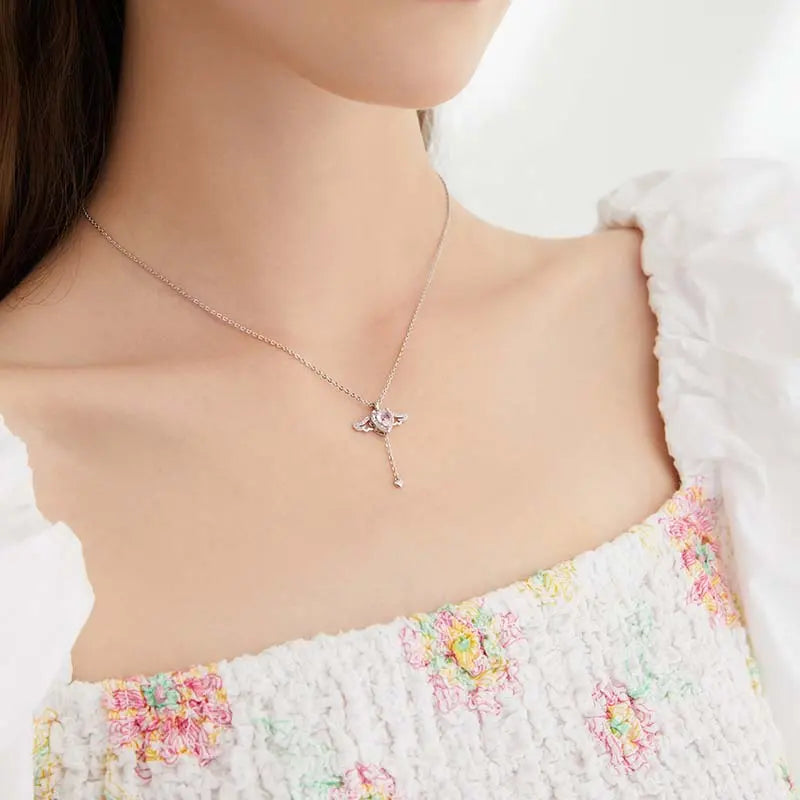 Delicate gold-plated pendant necklace with crystal accents on woman's neck, elegant style