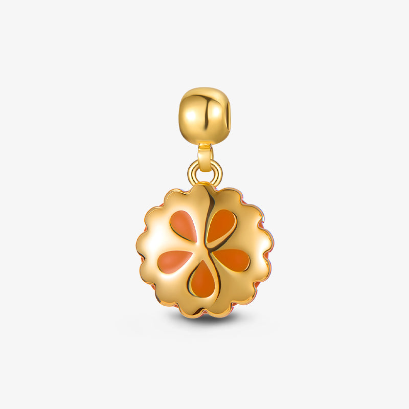 Gold-plated clover pendant charm with orange enamel on white background