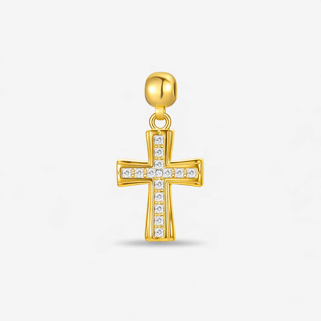 Gold-plated cross pendant with cubic zirconia stones on a plain white background.