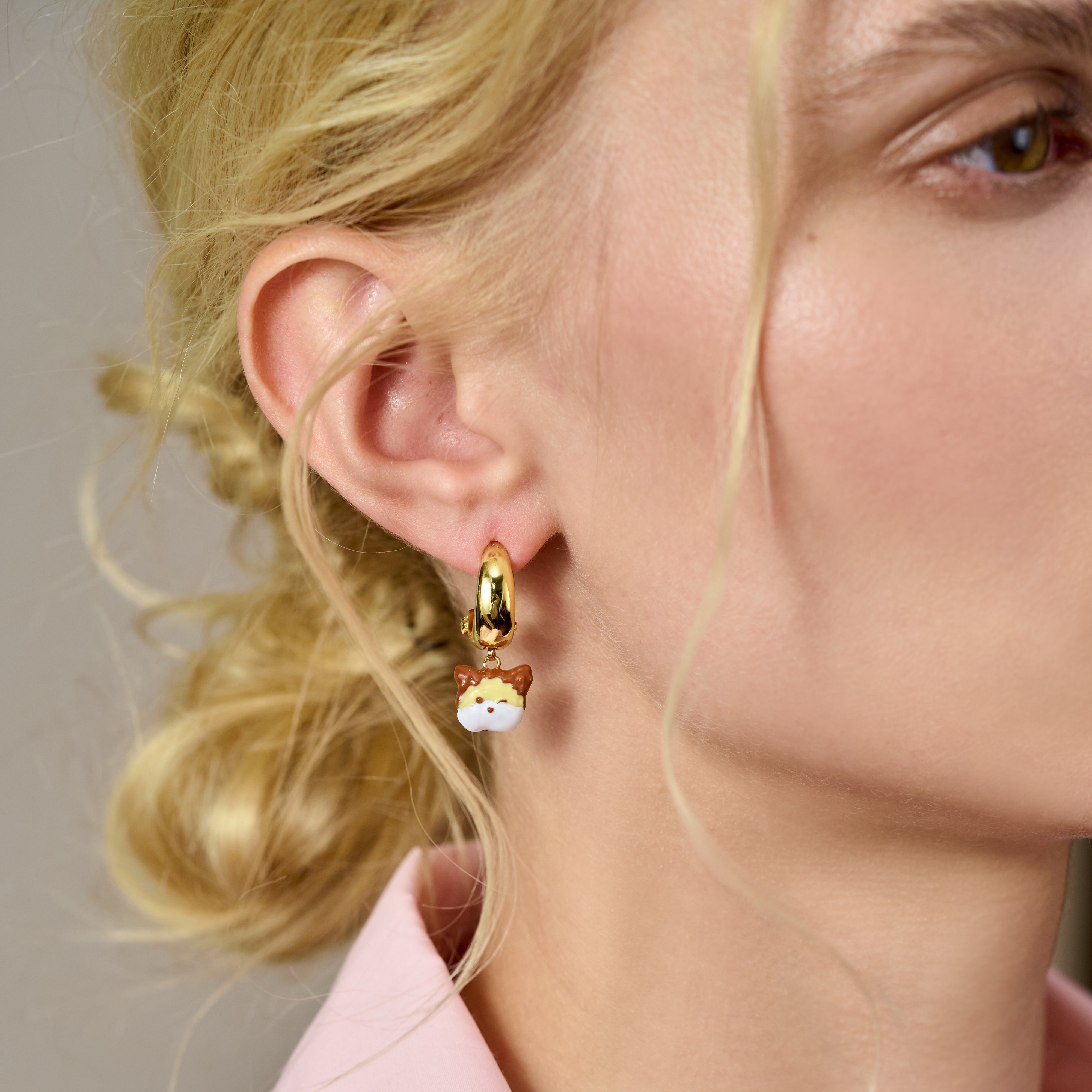 Gold-plated hoop earring with cat pendant on woman with blonde hair