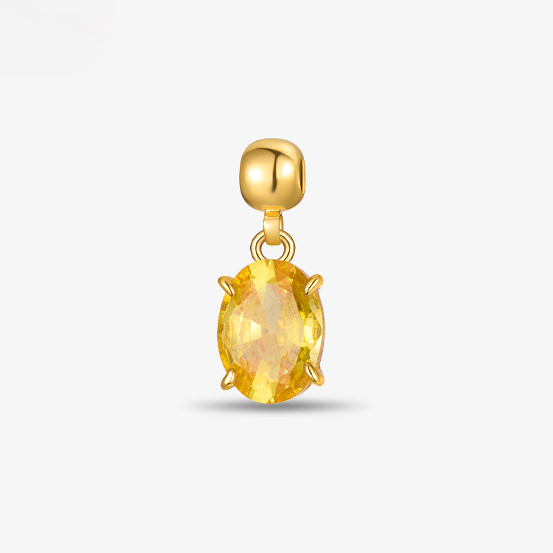 Gold-plated pendant with oval yellow gemstone, elegant jewelry on white background