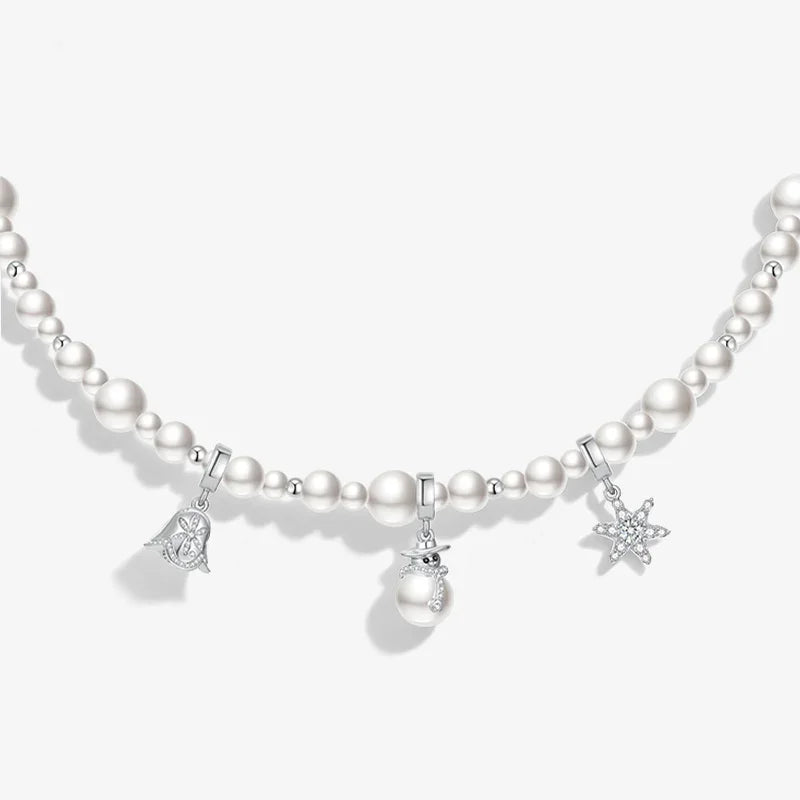 Pearl beaded necklace with silver snowflake, bell, and snowman charms on white background