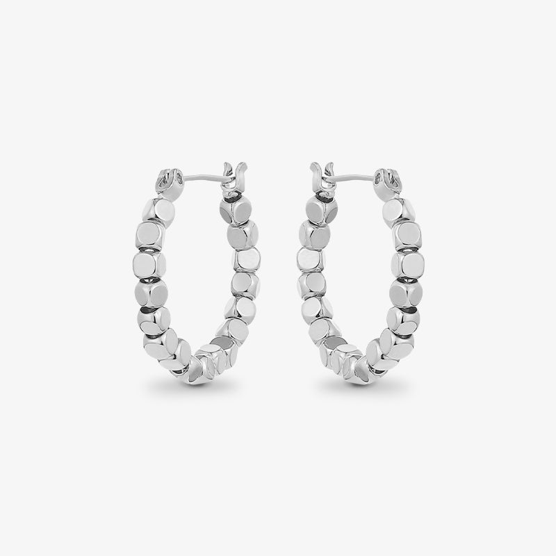 Silver beaded hoop earrings with polished finish on white background