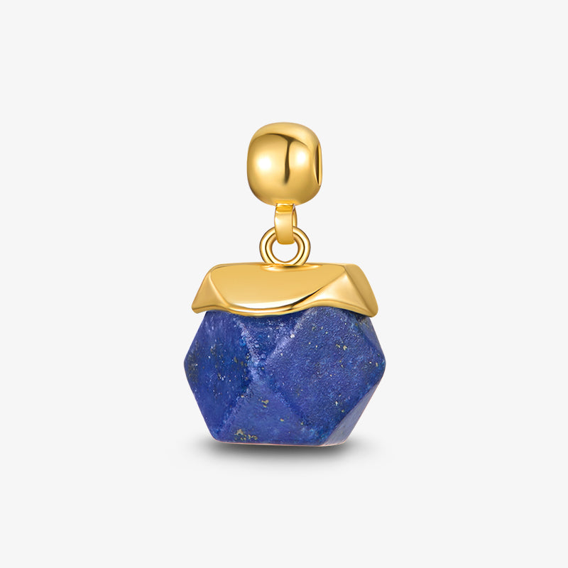 Gold-plated pendant with faceted blue stone on white background, elegant jewelry charm