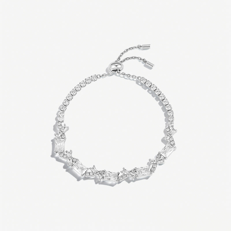 Elegant silver adjustable bracelet with clear rectangular and round crystals on white background