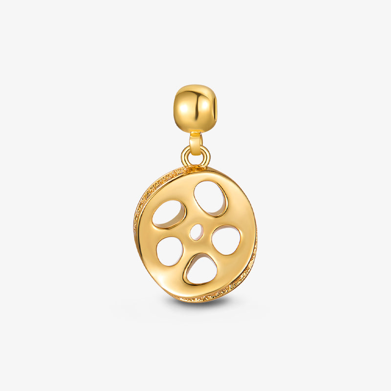 Gold-plated dangle charm with abstract cutout round design on white background