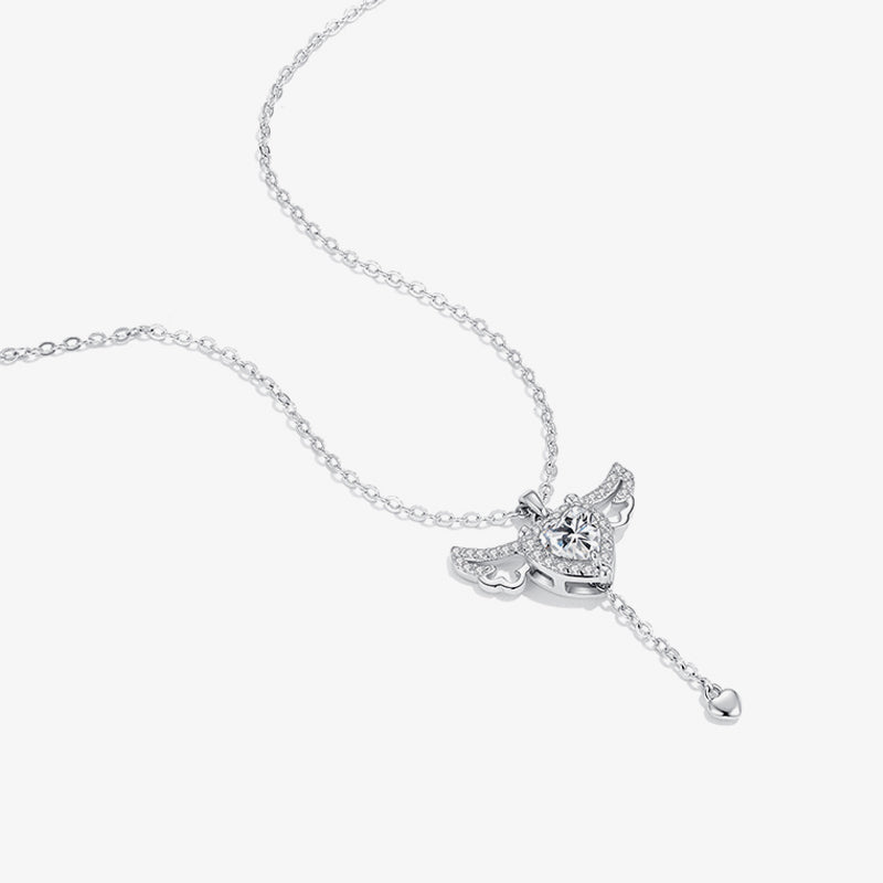 Silver heart pendant necklace with angel wing design and cubic zirconia accents on white background