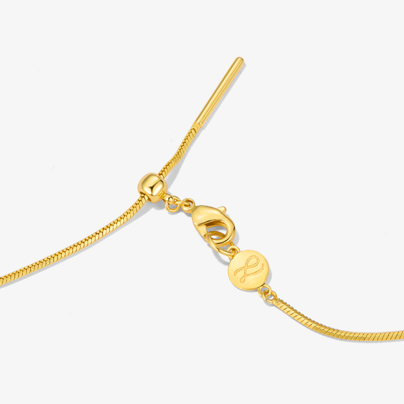 Gold-plated adjustable necklace with lobster clasp and engraved round charm on white background