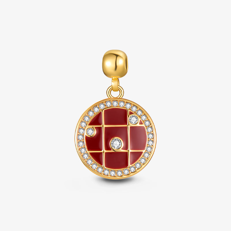 Gold-plated round charm pendant with red enamel, grid pattern, and sparkling crystal accents.