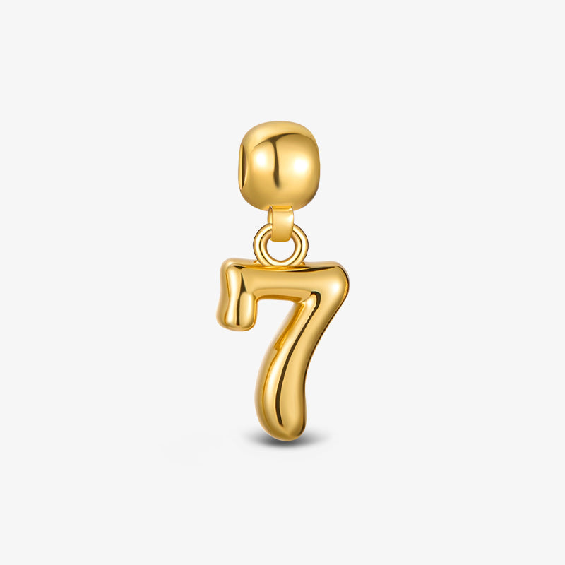 Gold-plated number 7 pendant charm on white background, minimalist jewelry accessory