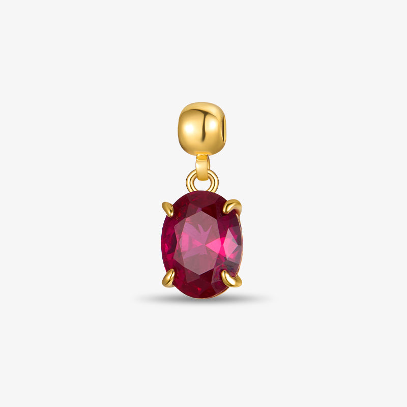 Gold-plated charm with oval red gemstone, elegant jewelry accessory on white background