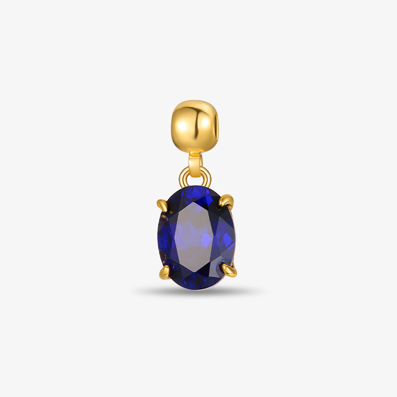 Gold-plated pendant with oval blue gemstone, elegant jewelry on white background