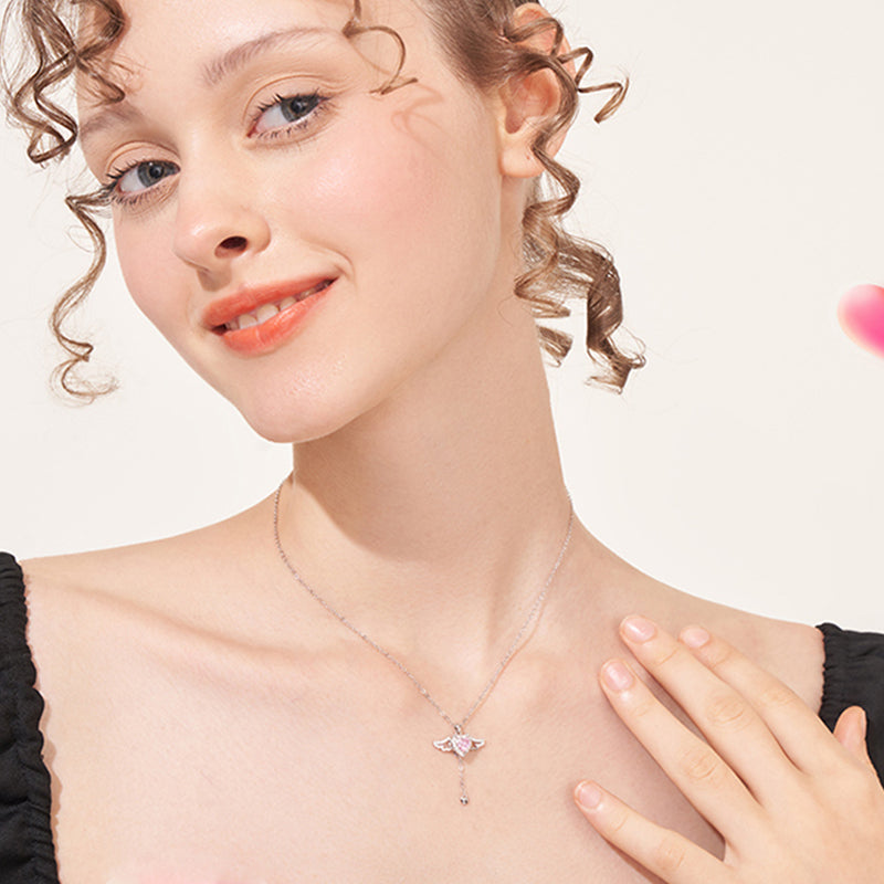 Woman wearing a delicate butterfly pendant necklace and black top, elegant jewelry close-up